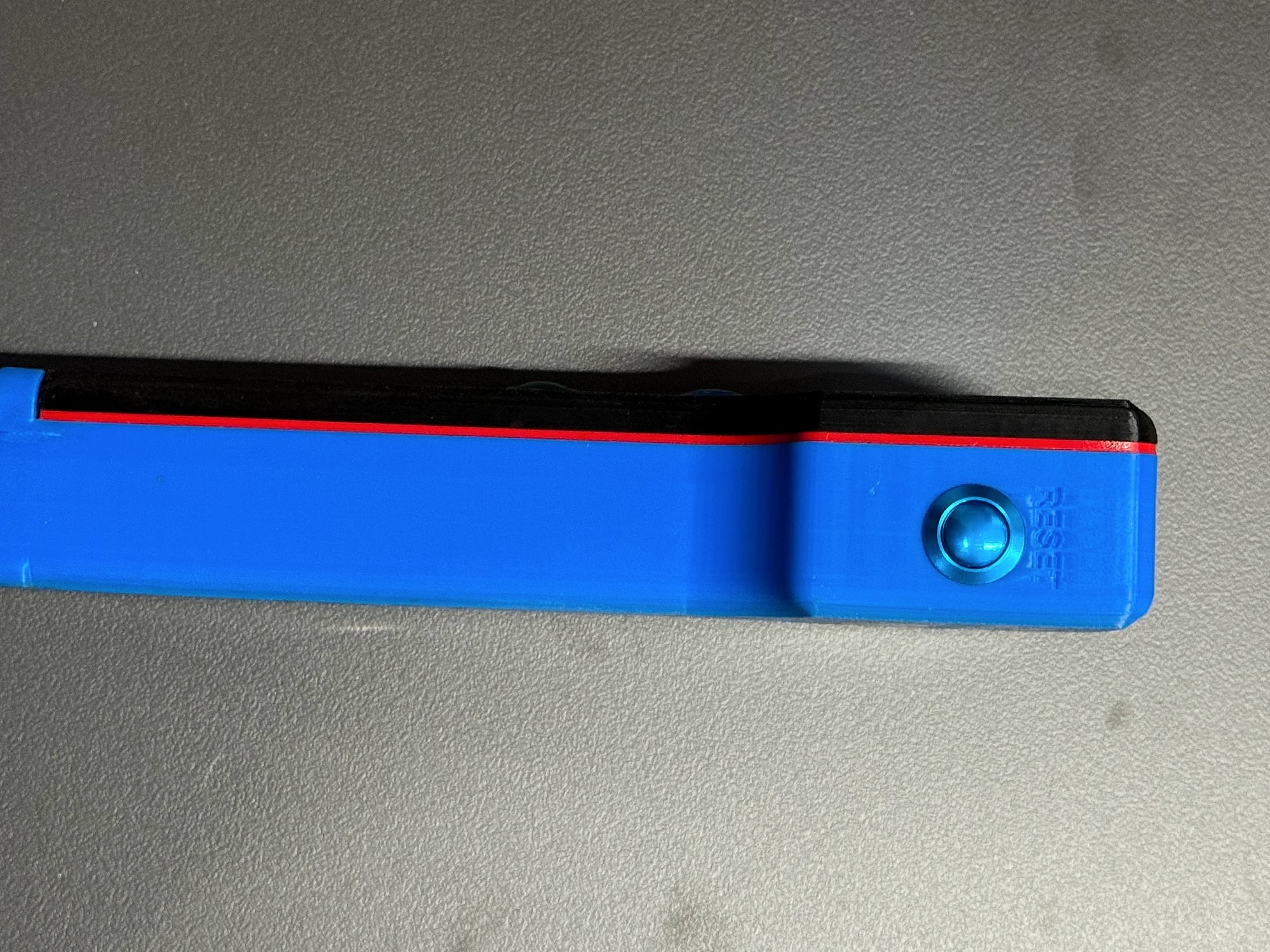 Reset button on the blue housing of the remote control